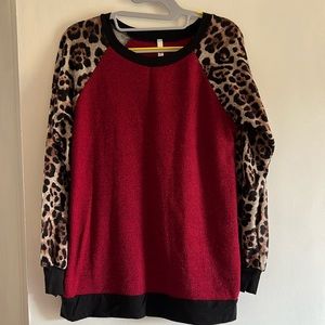 Holiday sweater with leopard sleeves